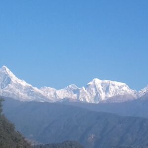 Close-up view of snow-capped peaks in the Annapurna mountain range, including the prominent Machapuchare (Fishtail) mountain, as seen from the Royal Trek in Nepal.